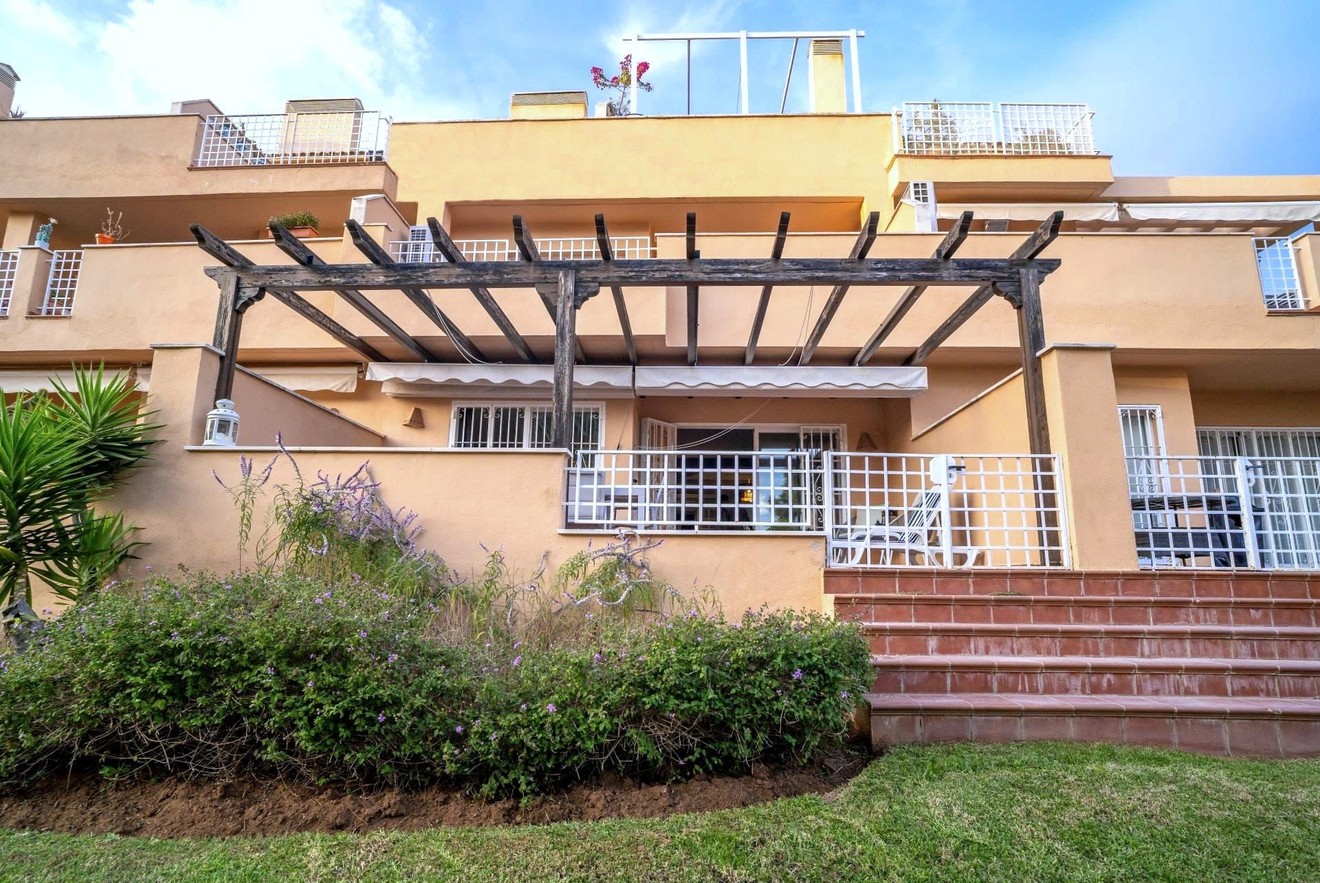 The apartment building with the terrace and pergola