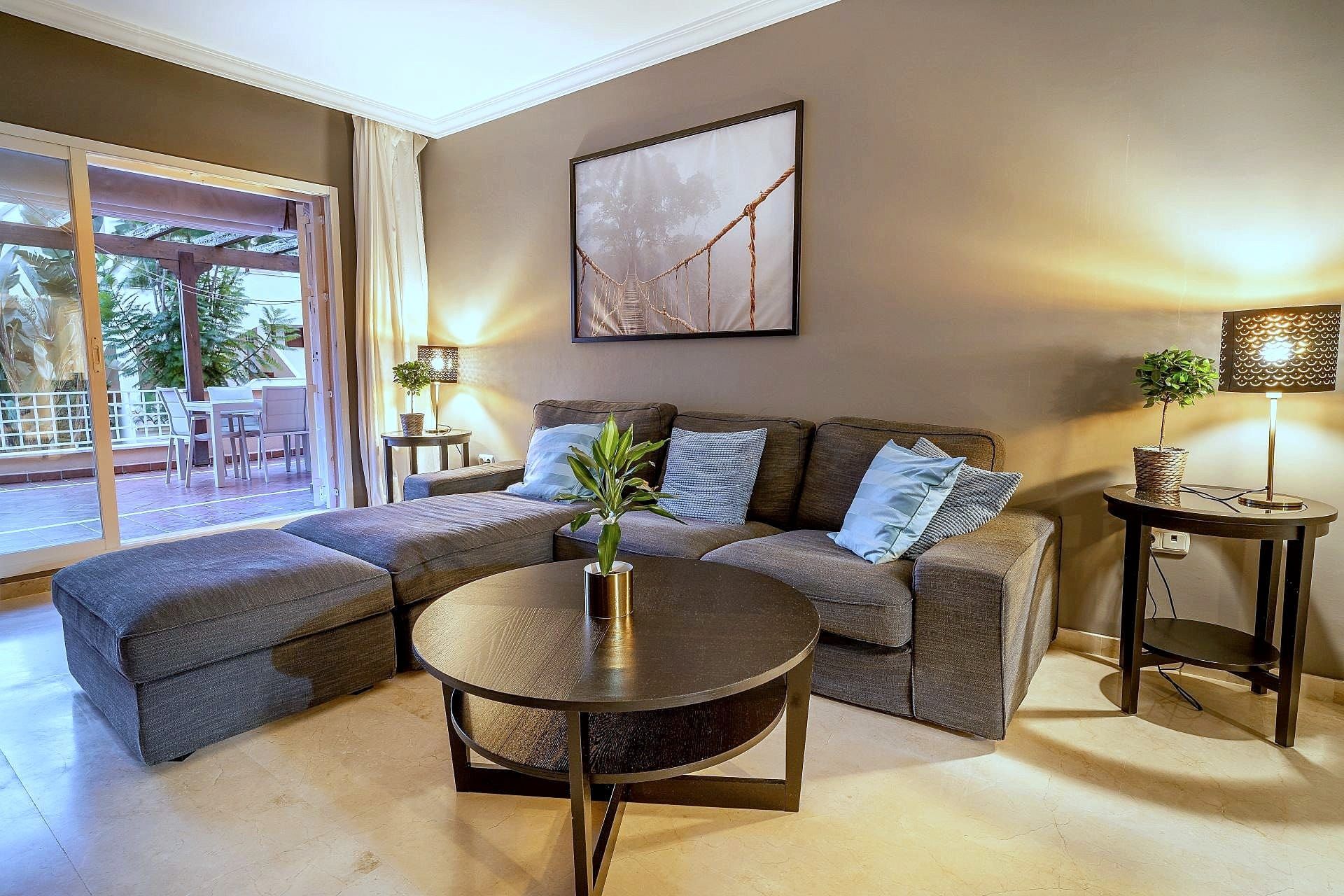 Corner sofa in the living room with the terrace behind