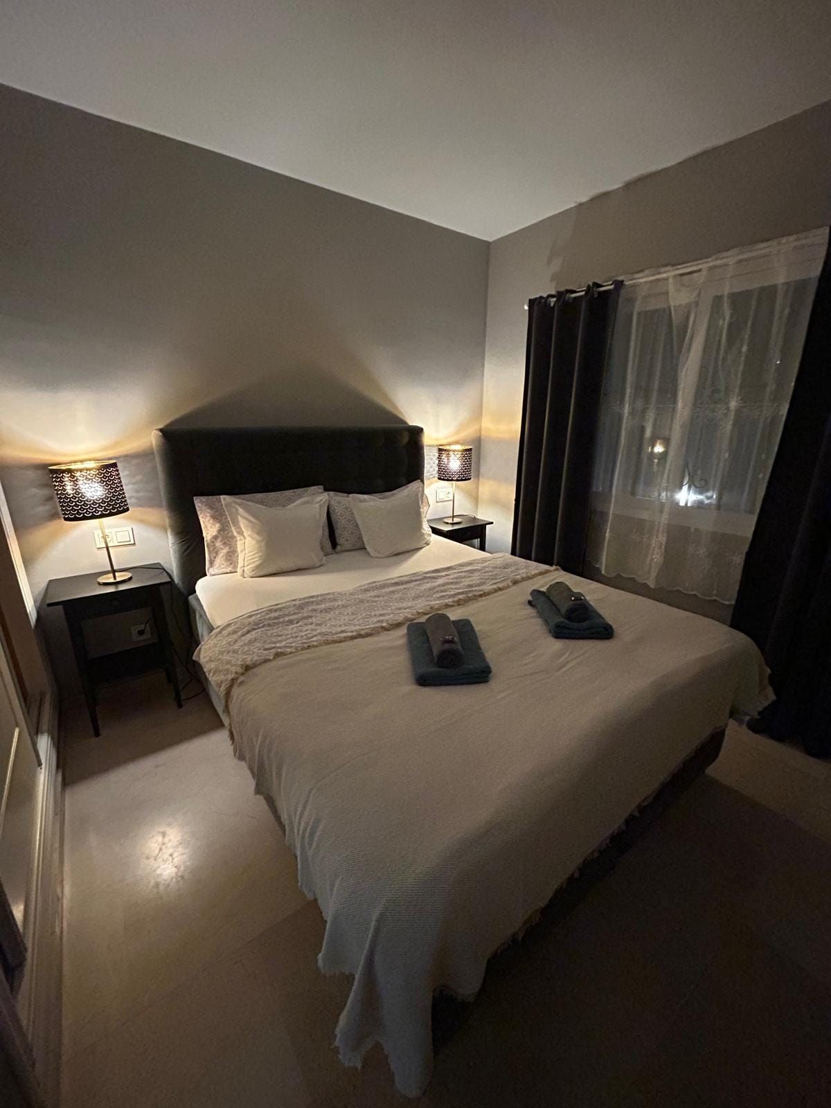 Main bedroom with bedside lamps on